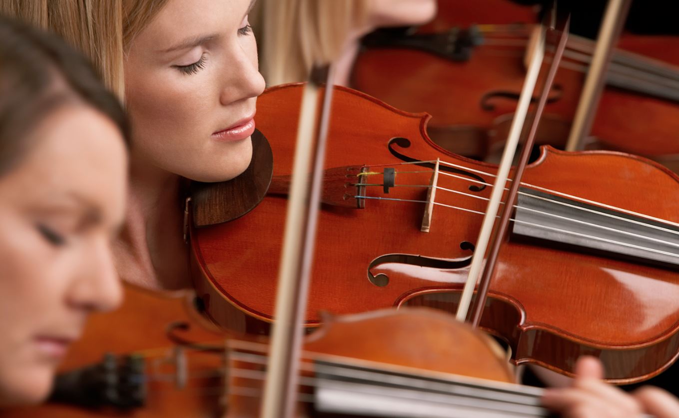 This is an image of a few girls playing the violin and relieving stress