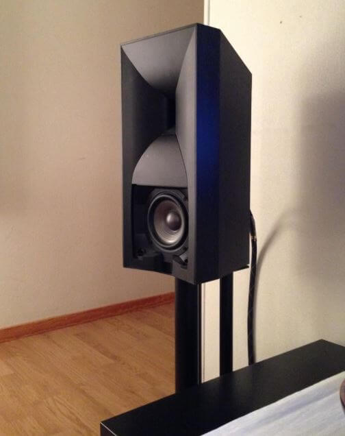 image of the jbl 530 on a bookshelf speaker stand