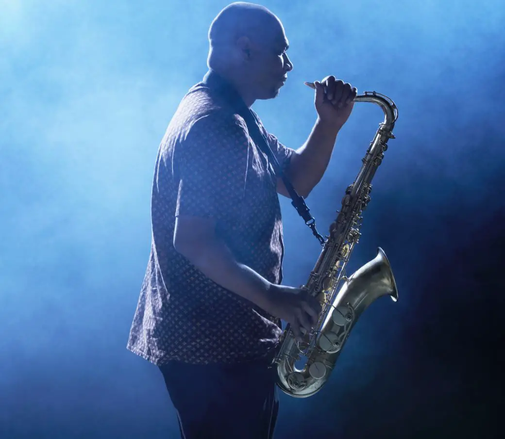 Man playing saxophone in a smokey jazz club